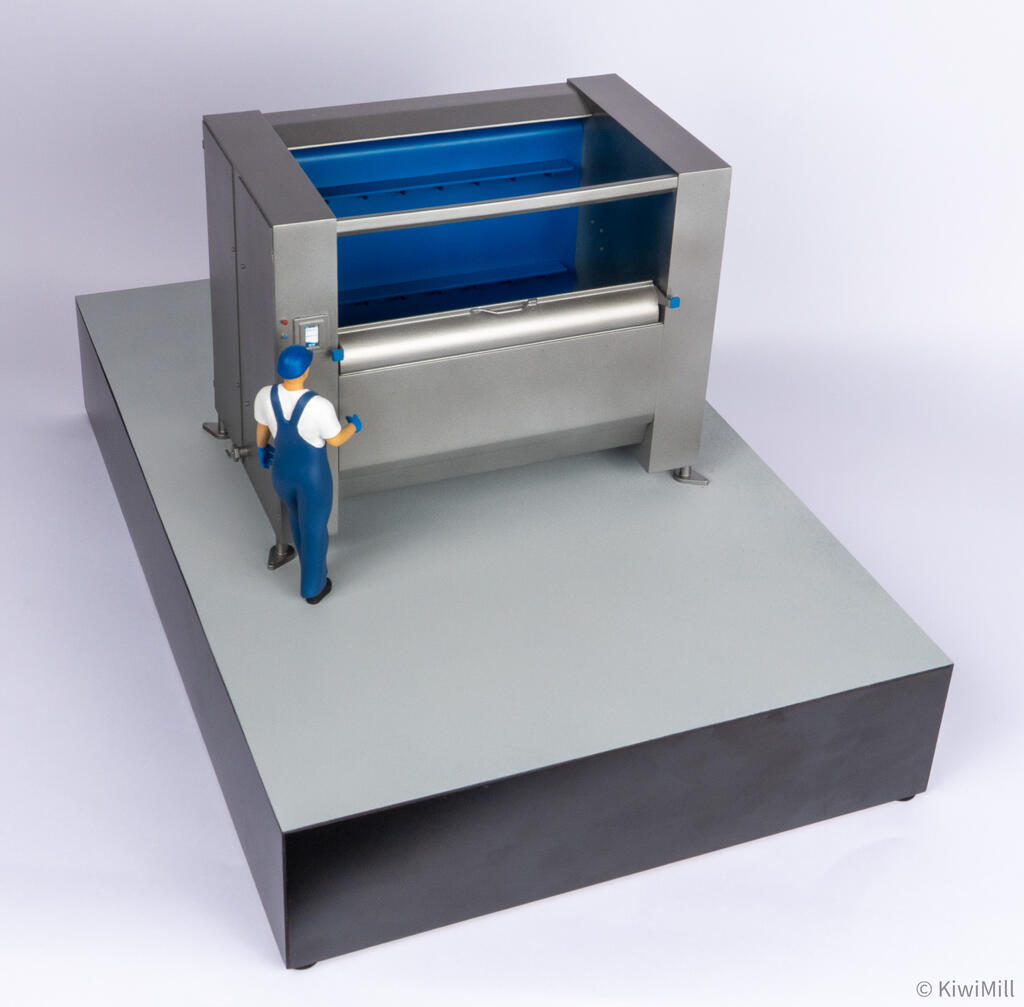 High front three-quarter view into the chiller model's blue belt tank, showing raised flights and front lip handle